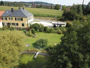 an aerial view of a house and a pond in a yard at Genesungsort Landhaus Dammert in Oppach