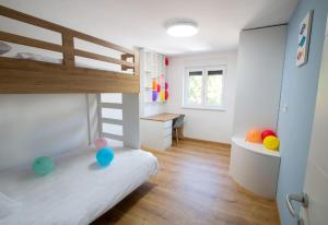 ein Kinderzimmer mit einem Etagenbett und einem Schreibtisch in der Unterkunft Apartment Nauta Lux in Malinska