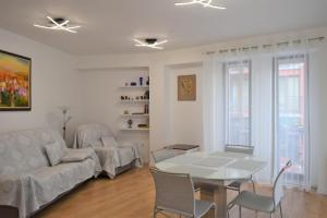 a living room with a table and a couch at Top center apartment Gramophone with private parking in Burgas City +31 photos