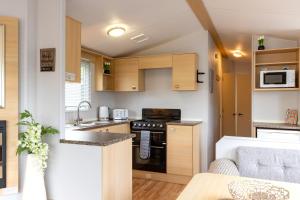 a small kitchen with a sink and a stove at Inside No 9 Retreat Carnforth in Carnforth