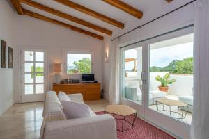 a living room with a couch and a sliding glass door at Charming house in San Pantaleo in Olbia
