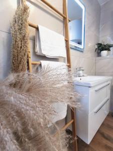 a bathroom with a white sink and a mirror at Elegance Suite Martina in Orebić