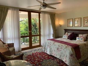 A bed or beds in a room at Mountain Rose Guesthouse