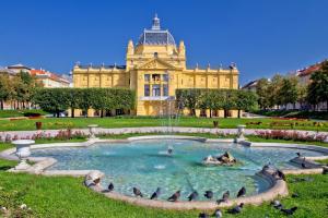 a building with a fountain in the middle of a park at Apartment in Zagreb with balcony, W-LAN, washing machine 4292-1 in Zagreb