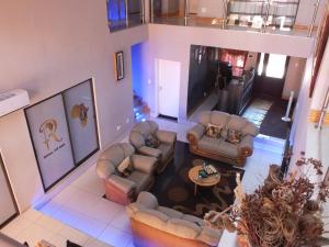 an overhead view of a living room with couches and a table at Royal Castle Guest House in Windhoek