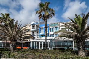 a building with palm trees in front of it at PAMPHYLIA HOTEL in Valencia