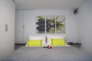 a bedroom with a bed with two yellow pillows at Holiday Home Relax - Mošćenička Draga in Mošćenička Draga