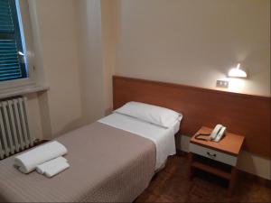 Postel nebo postele na pokoji v ubytování Albergo Italia
