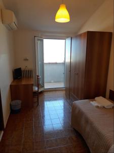 Postel nebo postele na pokoji v ubytování Albergo Italia