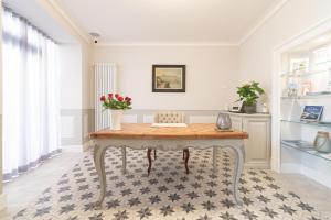 a dining room with a table with flowers on it at Antico Borgo B&B in Cannobio