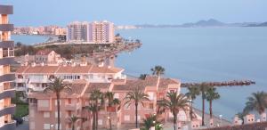 a view of a city with palm trees and buildings at La Manga Paradies zwischen den zwei Meeren in La Manga del Mar Menor