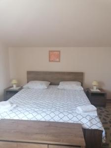 a bedroom with a large bed with two night stands at Apartments Vellico in Bale
