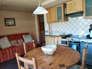 a kitchen with a wooden table in a room at la ratavelaiza in Champagny-en-Vanoise