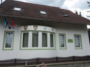 a white house with a brown roof at Raza Soarelui apartament de lux in Sovata