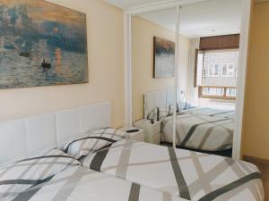 Кровать или кровати в номере Apartamento Argandona-Gijon