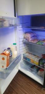 an open refrigerator filled with food and eggs at Self Contained Holiday Home Caravan in Corsham