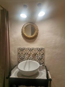 a bathroom with a large bowl sink on a wall at La Ferme de la Condamine in Saint-André-de-Rosans
