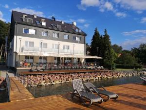 a building with a bunch of birds in the water at Dalma Panzió in Balatonvilágos