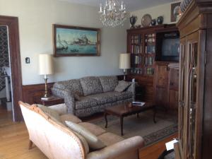 a living room with a couch and a tv at Stevenson Farms-Harvest Spa B & B in Alliston