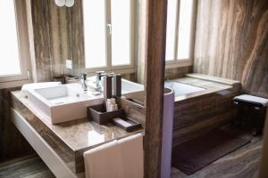 a bathroom with a sink and a large mirror at Liassidi Wellness Suites in Venice