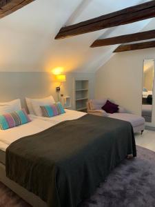 a bedroom with two beds and a couch at Halltorps Gästgiveri in Borgholm