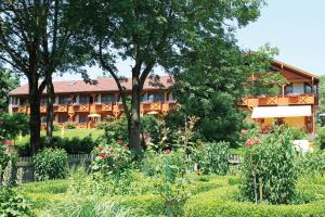 a house with a garden in front of it at Hotel Quellenhof in Bad Birnbach