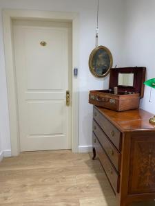 a room with a door and a dresser and a mirror at Villa Alba Boutique Hotel in Pescara
