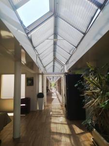 an empty hallway with a skylight in an office building at Hôtel L'ile Du Saussay in Itteville