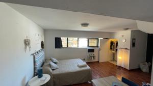 a bedroom with a bed and a living room at Blue Marine apartment in Pescara