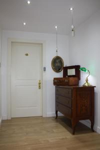 a room with a door and a dresser and a dresser with a clock at Villa Alba Boutique Hotel in Pescara