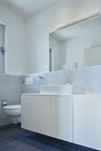 a bathroom with a sink and a mirror and a toilet at Villa Roca in Vis