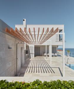 an external view of a house with the ocean in the background at Villa Roca in Vis