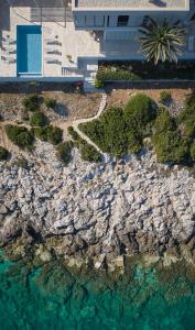 an aerial view of a rocky shore with water at Villa Roca in Vis