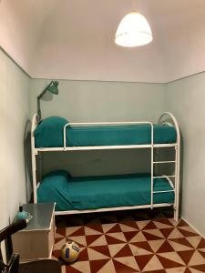 a room with two bunk beds and a lamp at Villa Dèco Monopoli in Monopoli