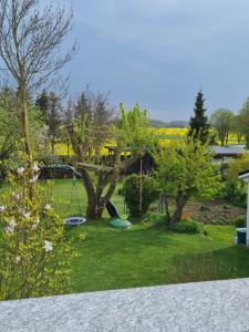 a playground in a yard with a swing at Ferienwohnung im Leuchtturmort Bastorf in Bastorf