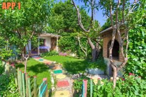 einen Garten mit einem Zaun neben einem Haus in der Unterkunft Apartments Dreamland in Baška