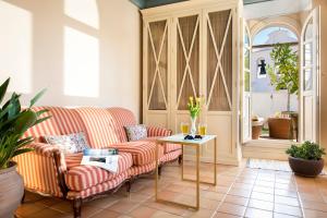 a living room with a couch and a table at CH Apartments Boutique in Seville +63 photos