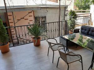 a balcony with a table and chairs and a couch at Shara Talyan 8/2 Guest House in Yerevan