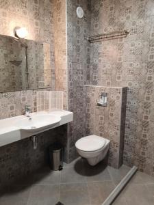 a bathroom with a toilet and a sink at VIDA in Lozenets