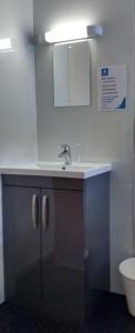 a bathroom with a sink and a toilet at Port Charlotte Youth Hostel in Port Charlotte