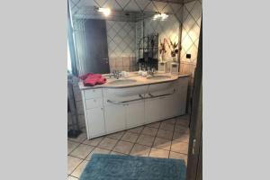 a bathroom with two sinks and a large mirror at BARDOLINO,LAGO DI GARDA, APPARTAMENTO,vacanze in Bardolino