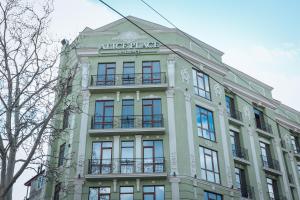 un gran edificio blanco con un cartel. en Alice Place Hotel, en Odessa