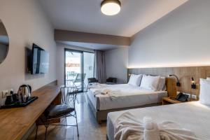 Łóżko lub łóżka w pokoju w obiekcie White Olive Elite Rethymno
