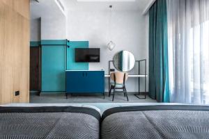 a bedroom with a bed and a desk with a mirror at PAMPHYLIA HOTEL in Valencia
