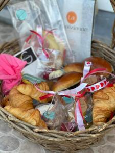 a basket filled with breads and pastries at Lo-Ghis Vakantieappartement Voerstreek 4P - 2slpk in Voeren +3 photos