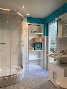a bathroom with a shower and a tub and a sink at Ferienwohnung Parkblick in Dransfeld