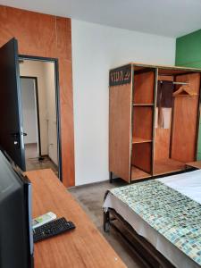 a room with a bed and a desk with a computer at VIDA in Lozenets +32 photos