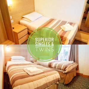 two beds in a hotel room with the words superior singles and twins at The Carlton Hotel in Ipswich