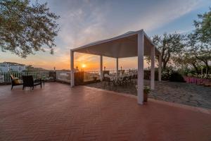 a gazebo with a table and chairs on a patio at Villa Carolina Sorrento with sea view Jacuzzi and Pool in Sorrento