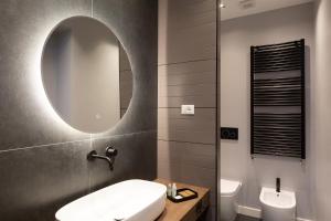 a bathroom with a sink and a mirror at CA’MILLA Luxury Apartments Trieste in Trieste +30 photos